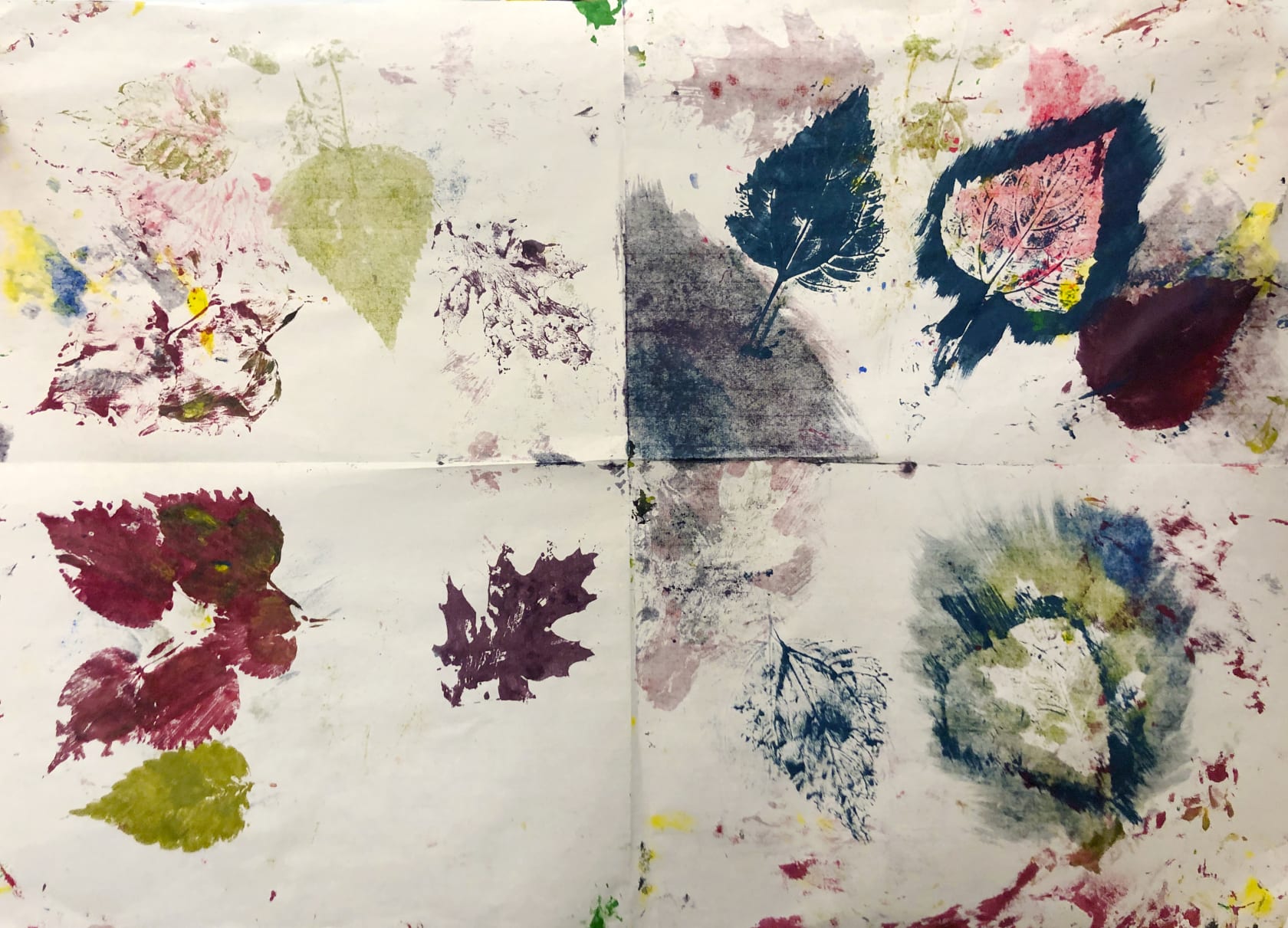 A colorful abstract painting utilizing prints of leaves