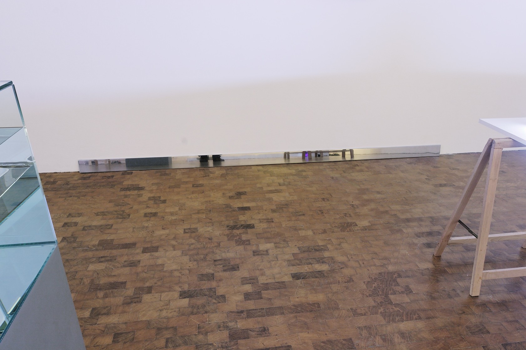 Untitled, 1990-2002 (detail) Aluminium, plinth Two aluminium pieces are mounted opposite to each other along two walls of the space....