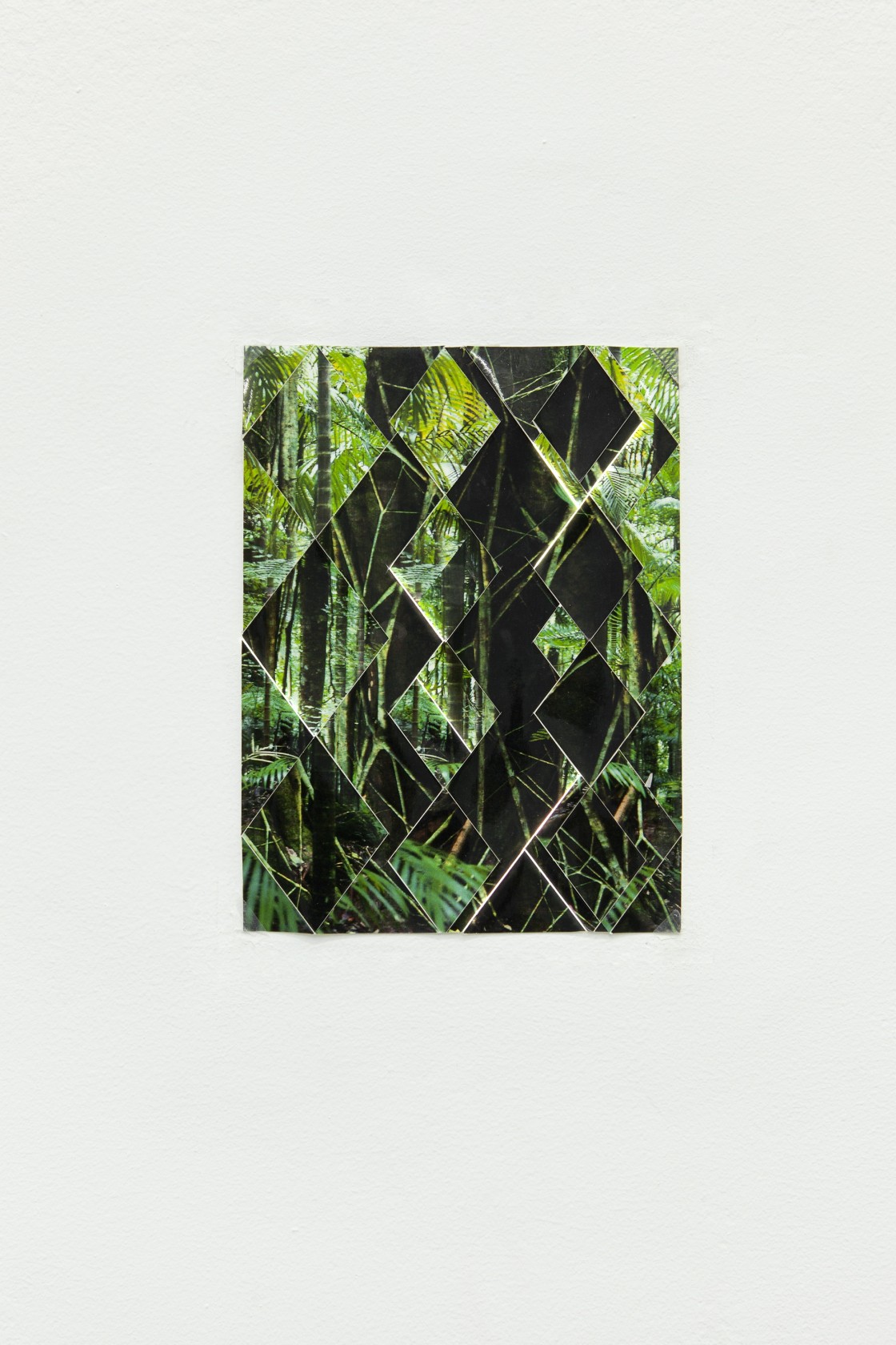 Kiti Ka’aeté (reverse), 2011 Slide projector, laser-cut steel slide, wall, hole, collage The collage, assembled from realigned rhomboid sections of...