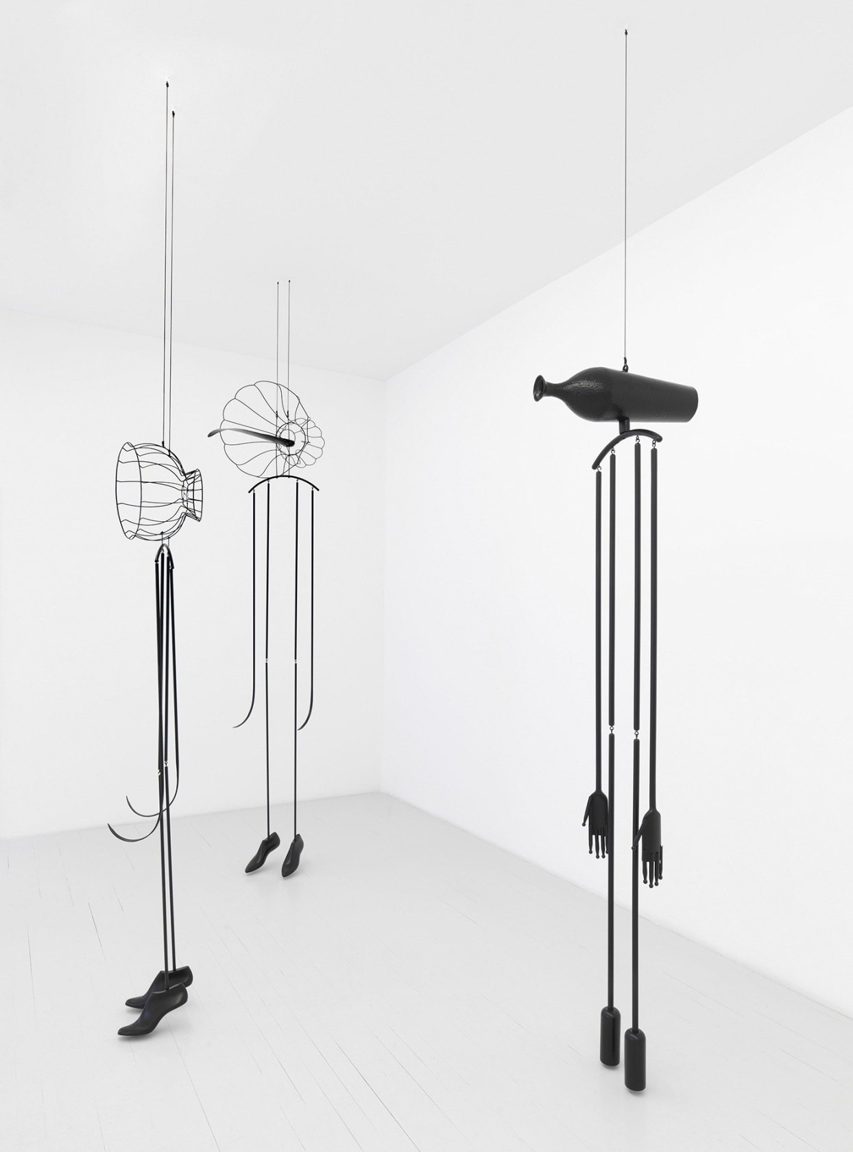 Eve, 2013 (left) Lampshade frame, metal pipes, shoe lasts, acrylic 223 x 50 x 50 cm Strange Strings, 2013 (center)...