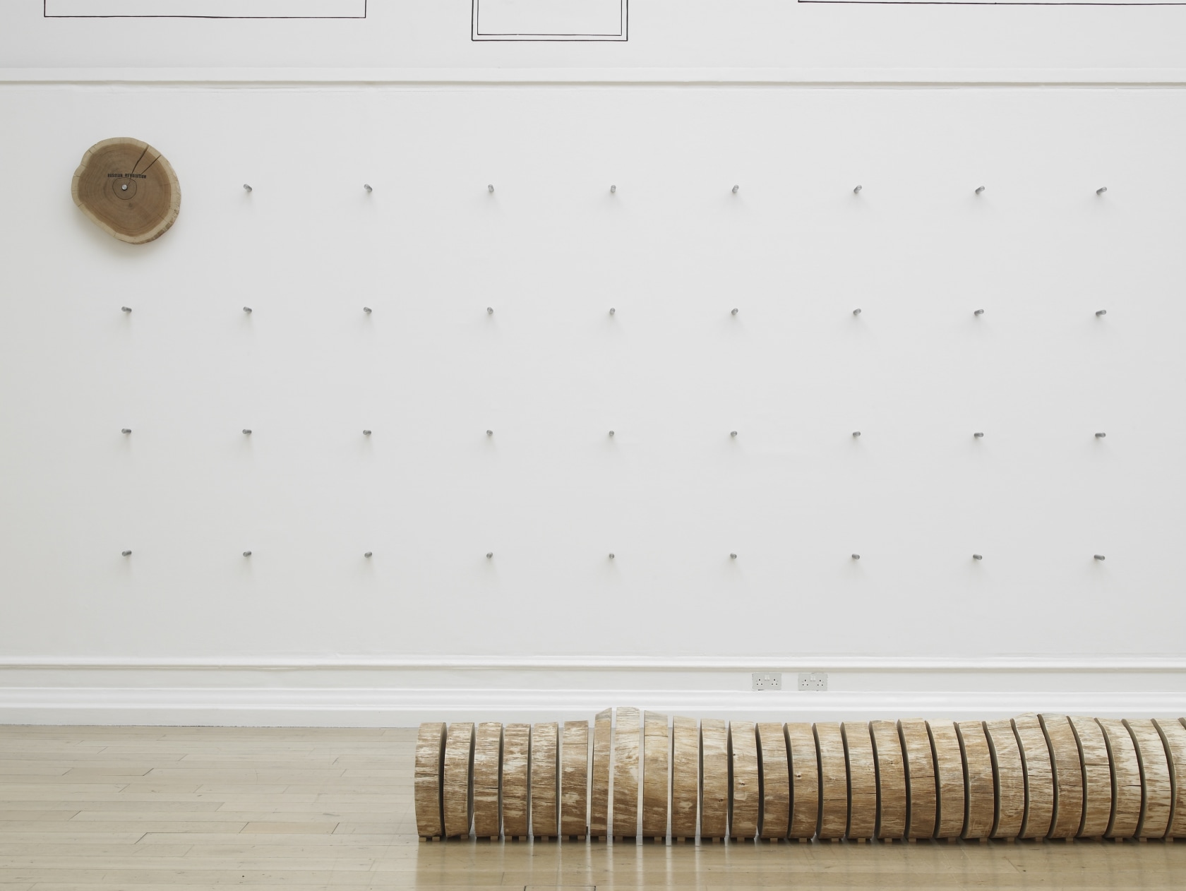 Event Horizon, 2016 (detail) Oak tree, stamped ink, acrylic paint, steel fixtures On each day of the exhibition, a pre-sawn...