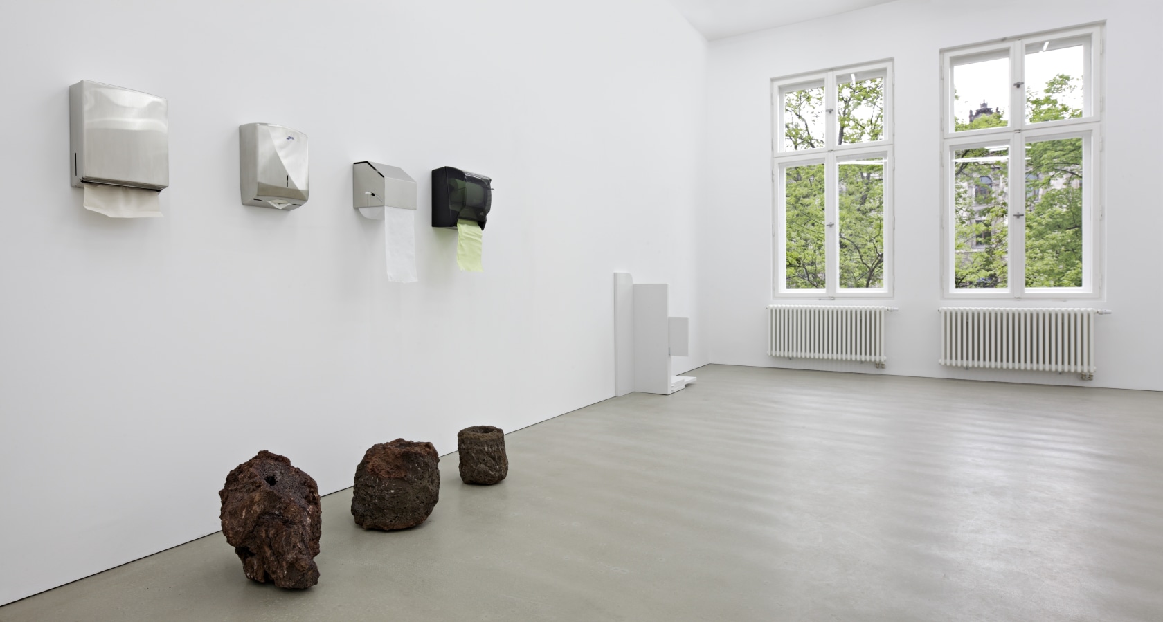 Soft Boxes 1, 2011 (front) 4 Wall mounted paper dispenser, paper, 3 volcanic rocks Untitled (CM 03 Deployment), 2011 (back)...