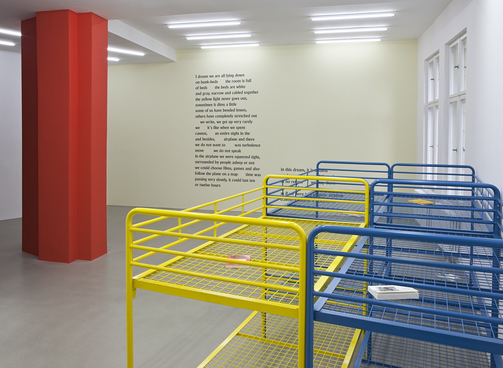Dublinesca (Installation), 2012 (front) 4 bunk beds (3 blue, 1 yellow), 8 books The exhibition space is transformed into a...