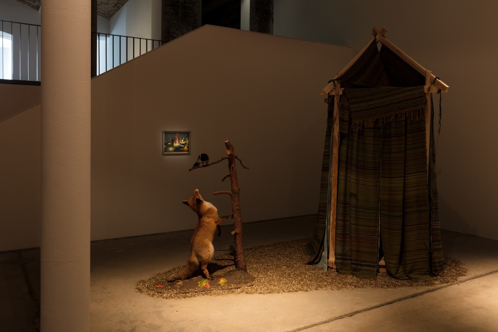 Treehouse, 2015 Mixed media installation (Ash wood frame with wool and linen woven textiles, taxidermized fox and magpie on tree...