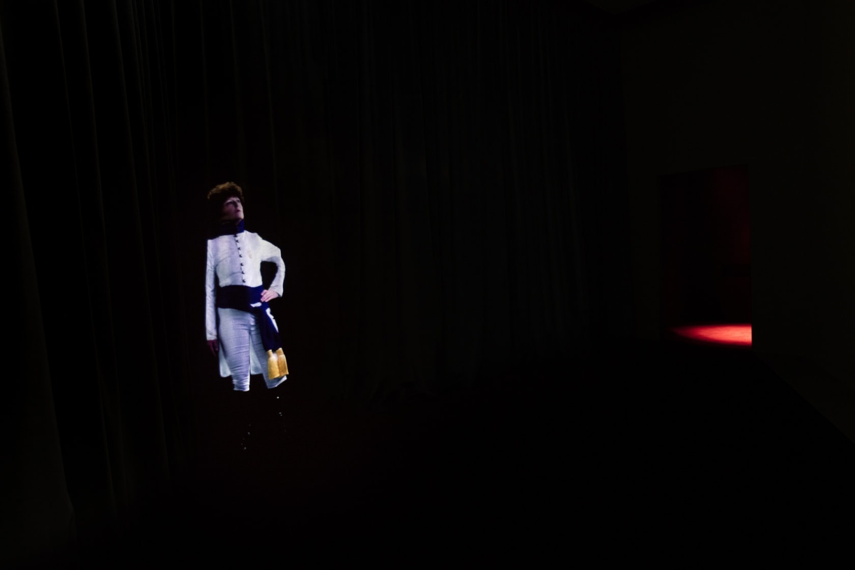 TEATRO (QM.15), 2016 HD video, projector, blue velvet curtain, media player, amplifier, speakers Duration 15:45 min Upon entrance, the visitor...