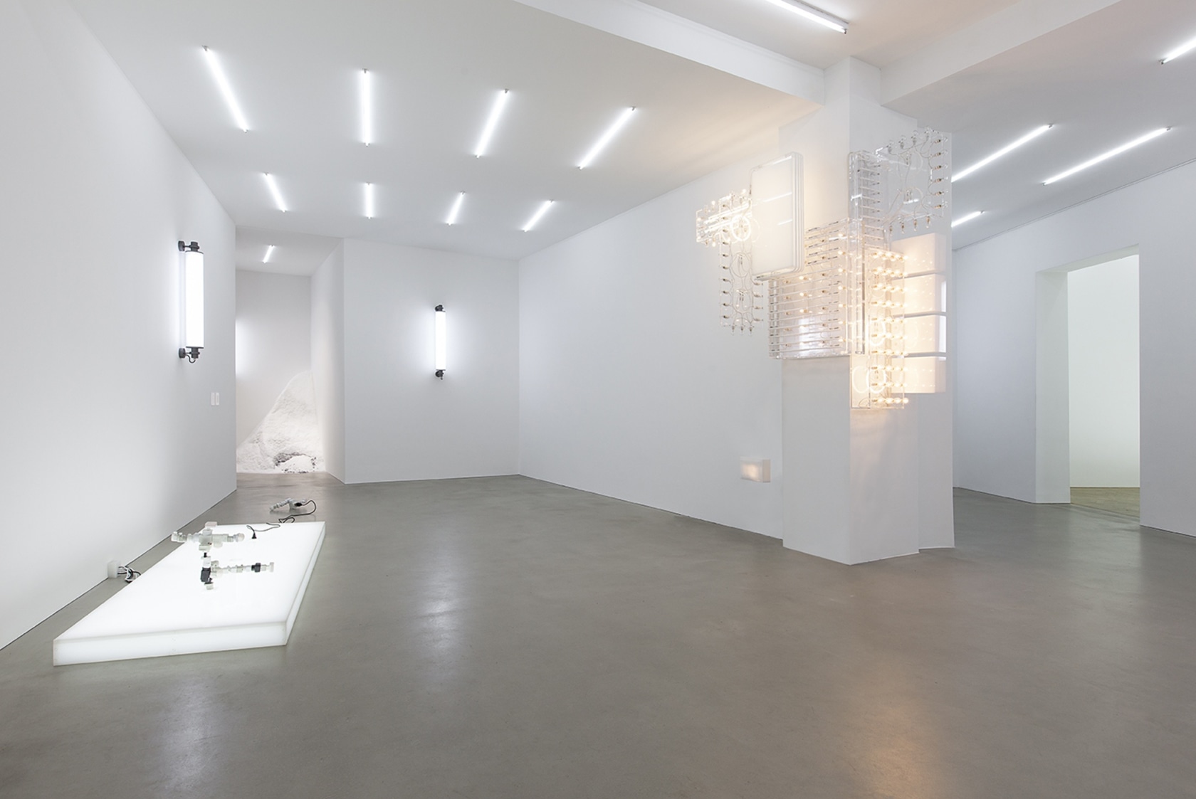 AC/DC Platform, 2013 (left) Opalescent acrylic glass podium, LED lights, 3 plugs, 2 AC/DC snakes Assembled from multiple adapters, plugs...