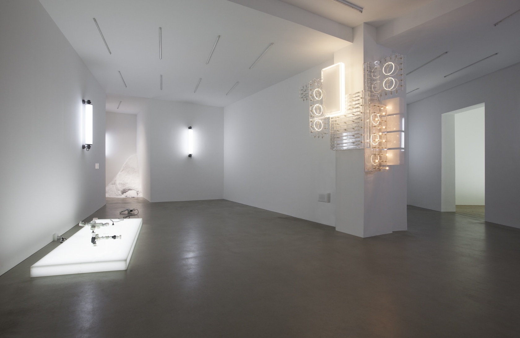 AC/DC Platform, 2013 (left) Opalescent acrylic glass podium, LED lights, 3 plugs, 2 AC/DC snakes Assembled from multiple adapters, plugs...