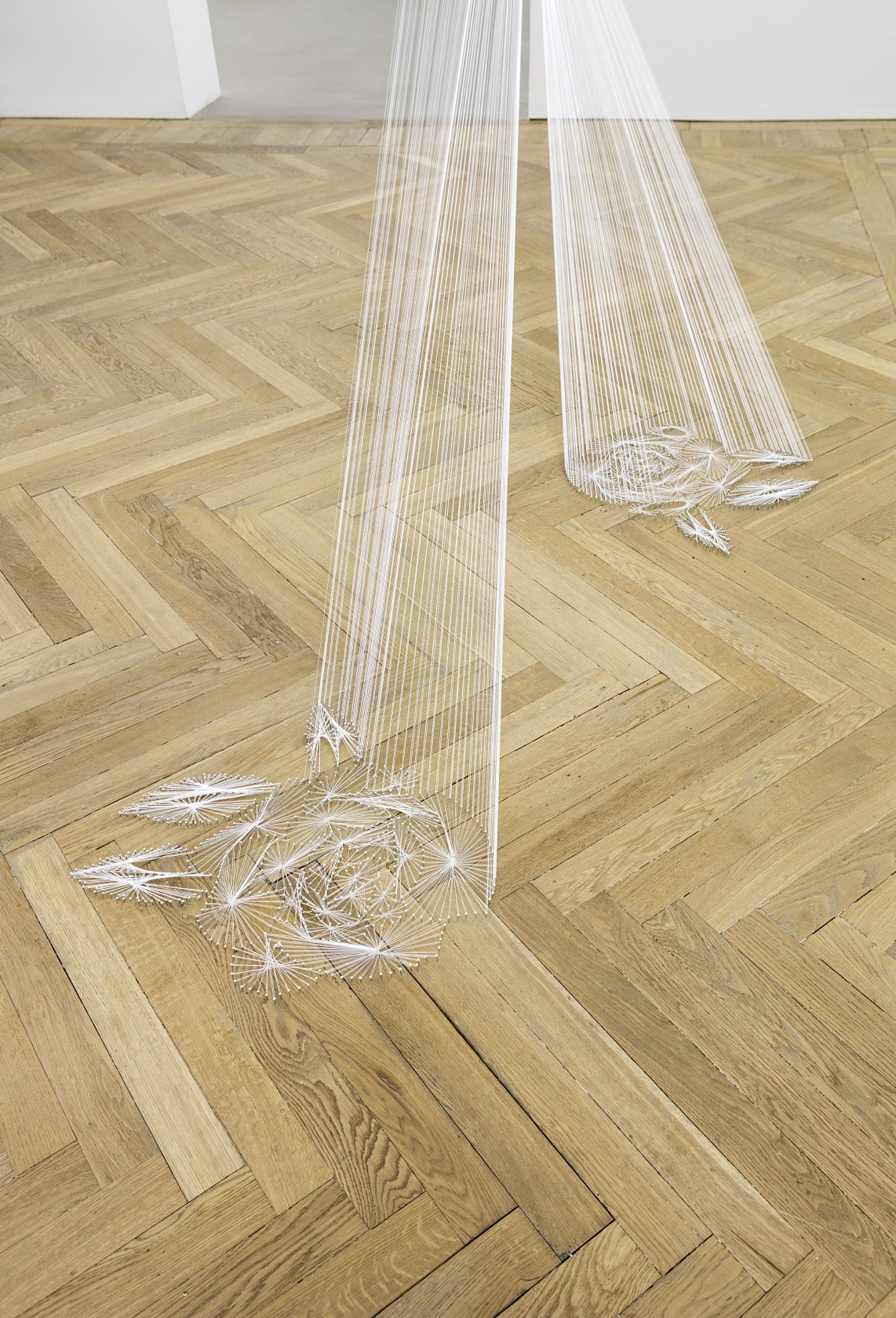Hyperboloïde IX, 2016 (detail) Thread, nails The architectural intervention connects different rooms. The threads originate from an ornamental floral pattern...