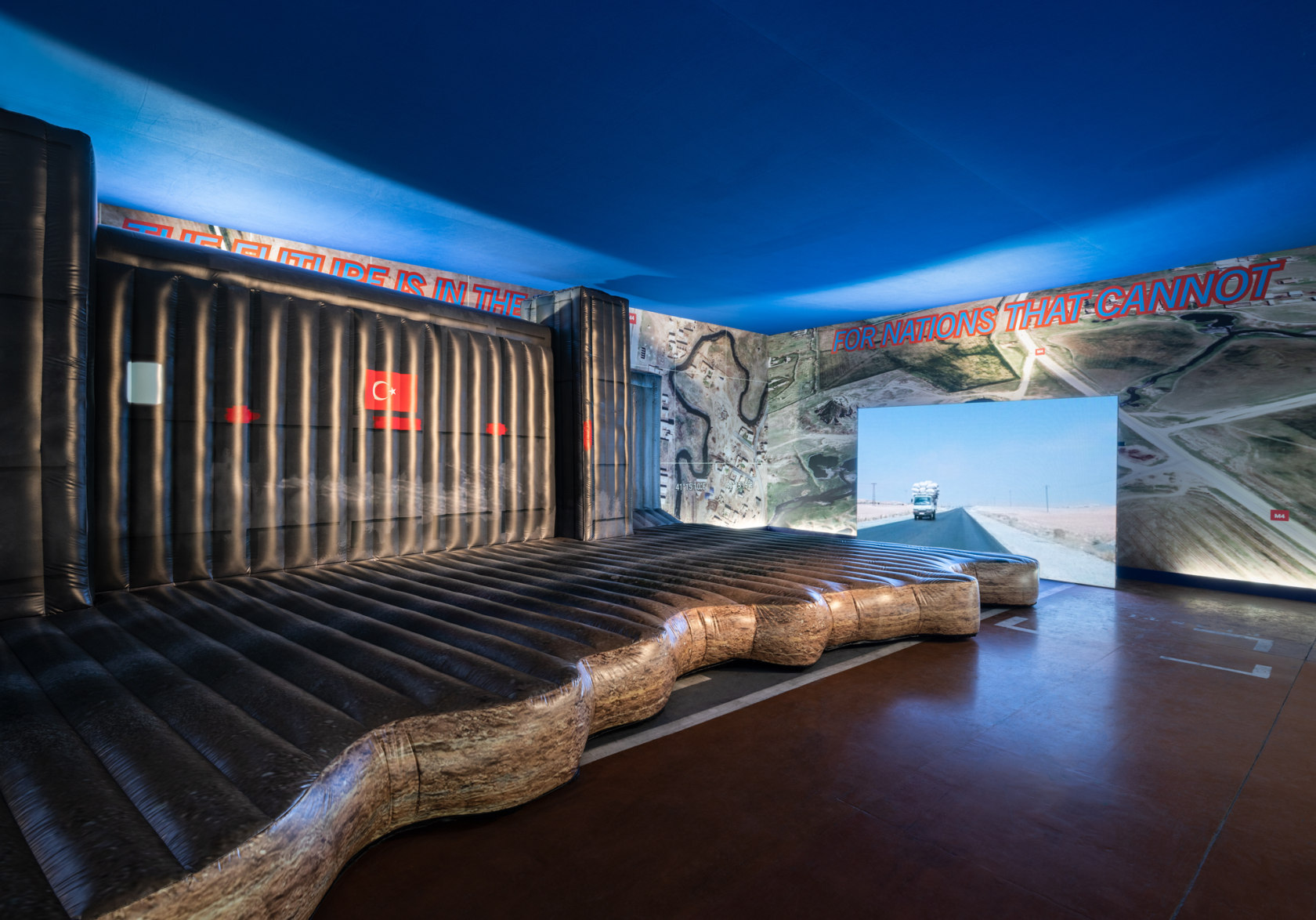 Cemile Sahin, Drone Valley, 2022, site-specific installation with inflatable checkpoint sculpture, video, sound and wallpaper, dimensions variable. Exhibition view: 16th...