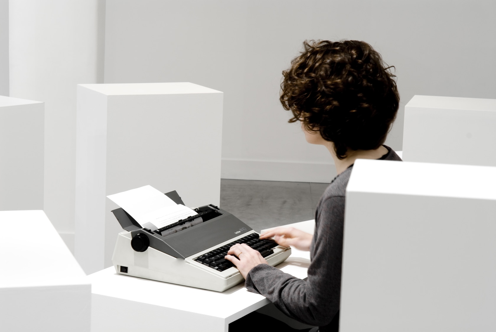 The Copyist, 2010 Writer, Typerwriter, A4 sheets of paper and plinths 45 x 40 x 29,7 cm, 72 x 70...