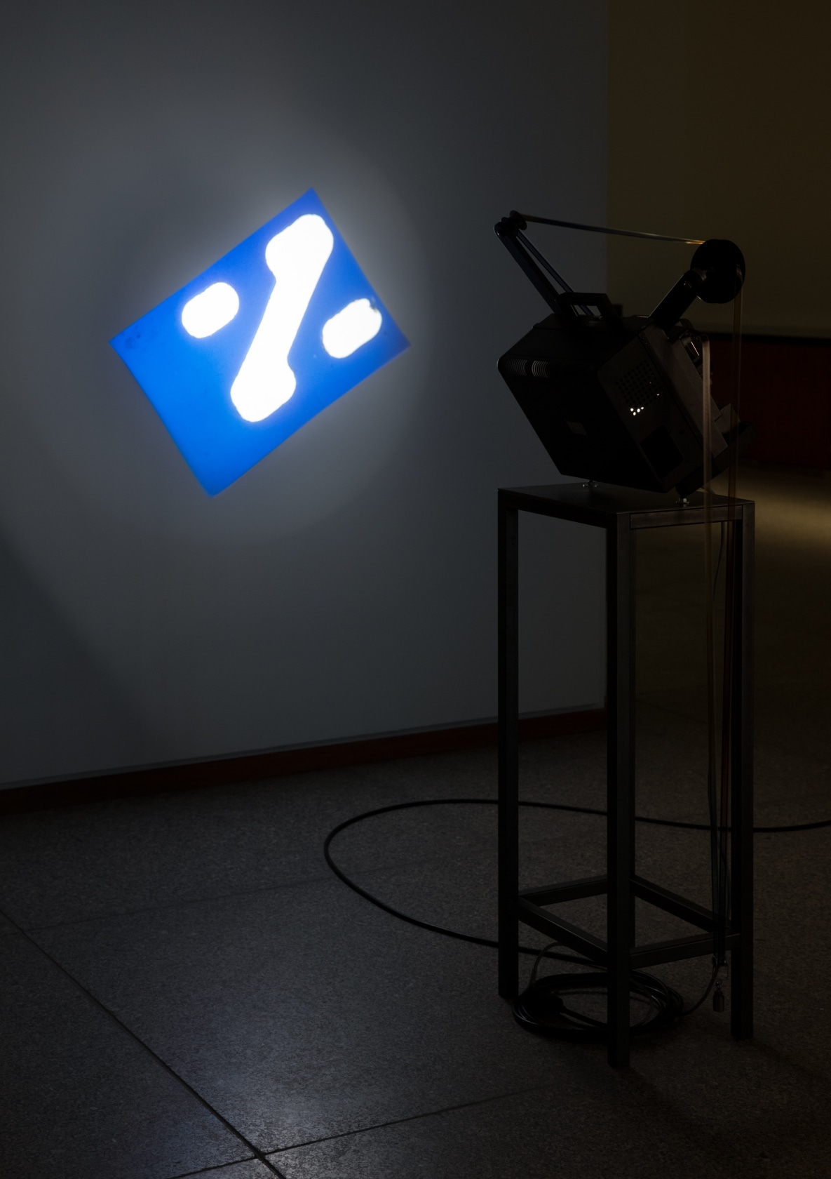 Rosa Barba The Long Poem Manipulates Spatial Organizations, 2014 Modified projector, plinth, stencil cut, 16 mm film (color) Dimensions variable...