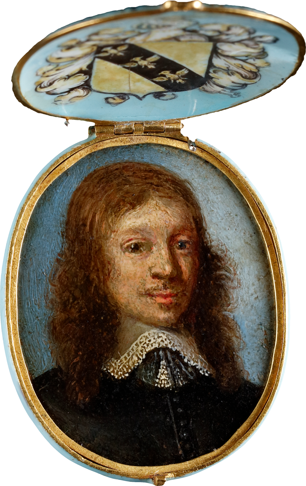 Oil on copper housed in contemporary enamelled gold locket frame, the pale blue base and lid decorated with gilded quatrefoils, the interior of the lid bearing a coat of arms, consisting of a diagonal band of three demi-eagles upon a shield surrounded by acanthus leaves with studded helmet and demi-eagle cresting Oval, 1 7/16 in (36 mm) high