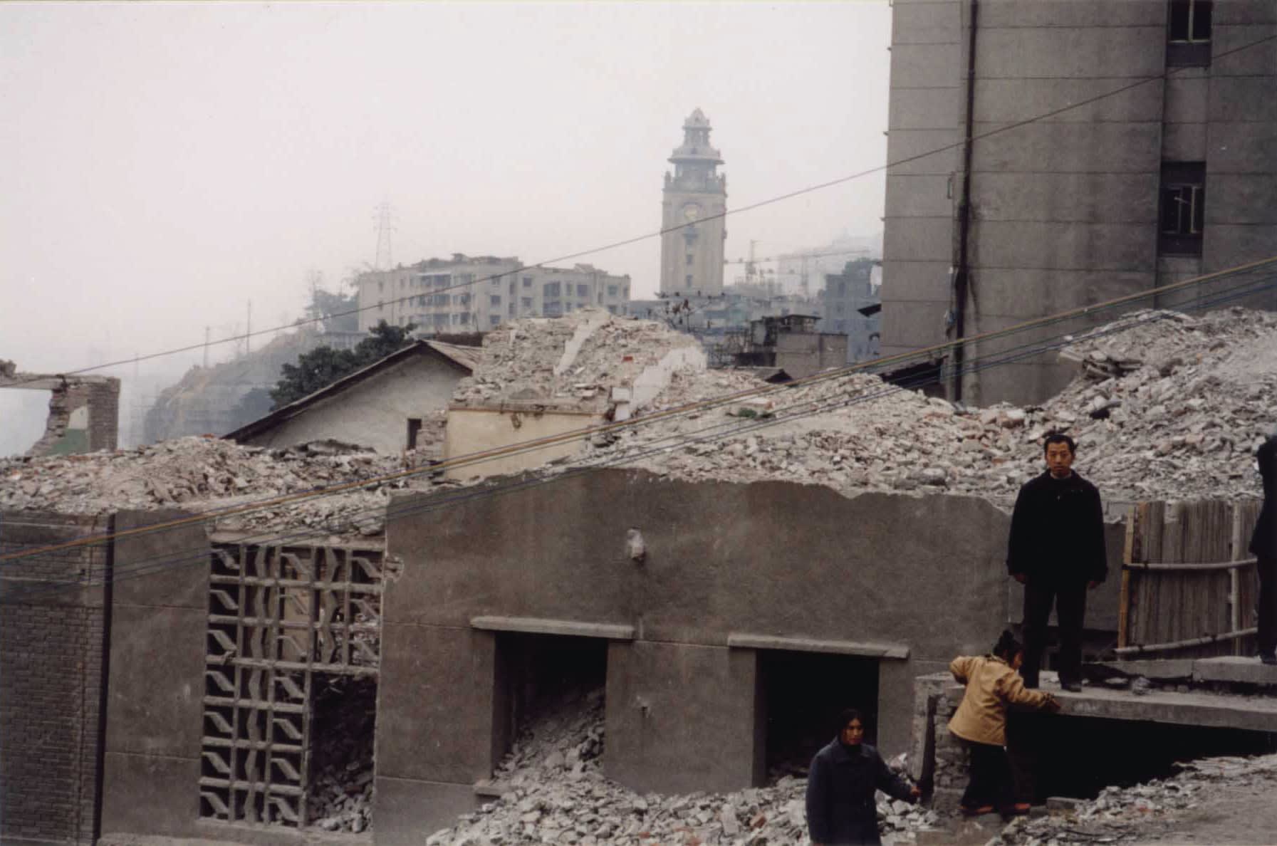 It is a video still from Farewell Poem 2002 that reveals a ruined construction site in Wanxian, Chongqing.