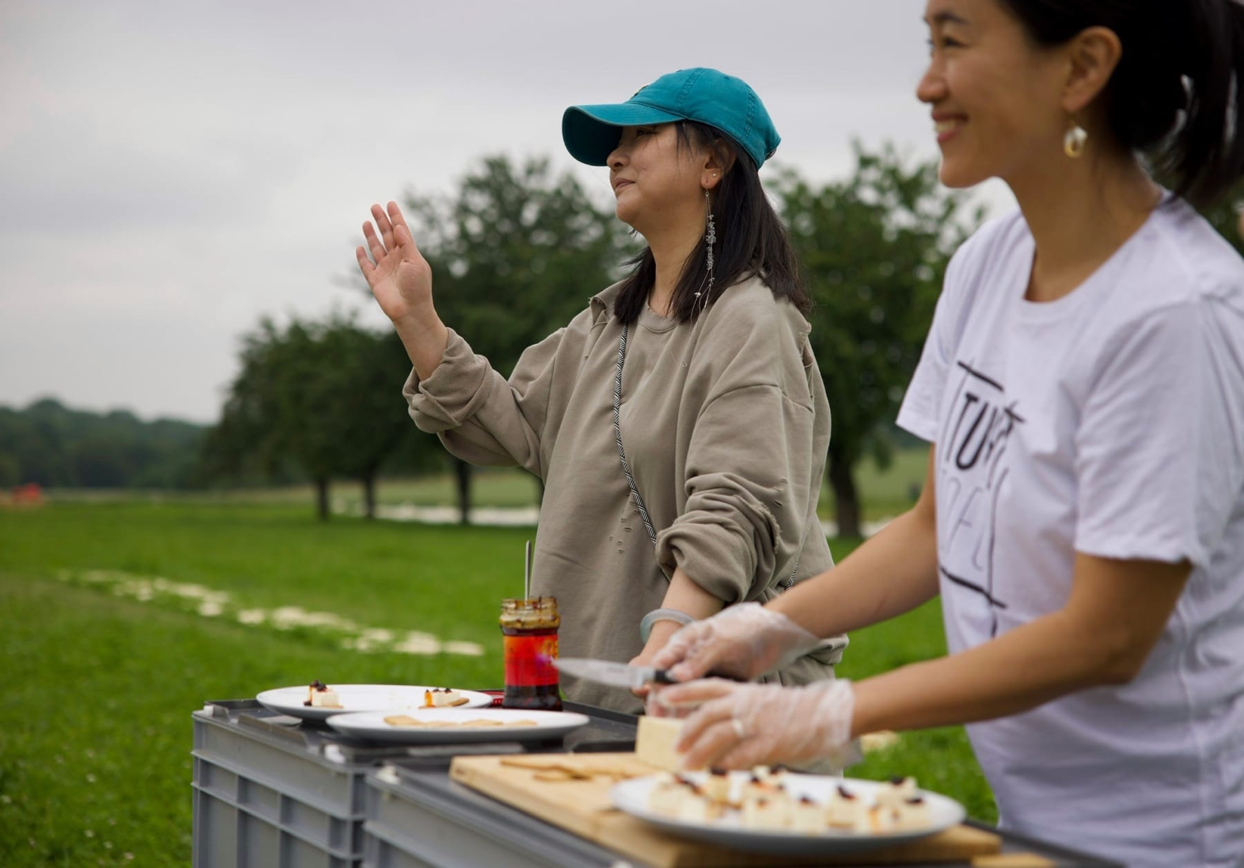 A close shot of artist Chen Qiulin and local tofu factory owner welcoming the visitors to taste the tofu.