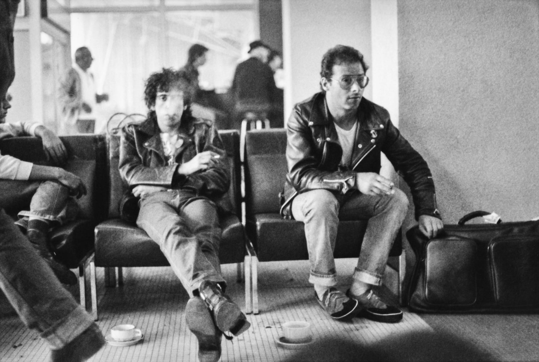 Caroline Coon, Mick Jones, lead guitarist of The Clash, and manager Bernie Rhodes at Heathrow airport on the way to The Second Punk Rock Festival, Mont de Marsan, France, 1977