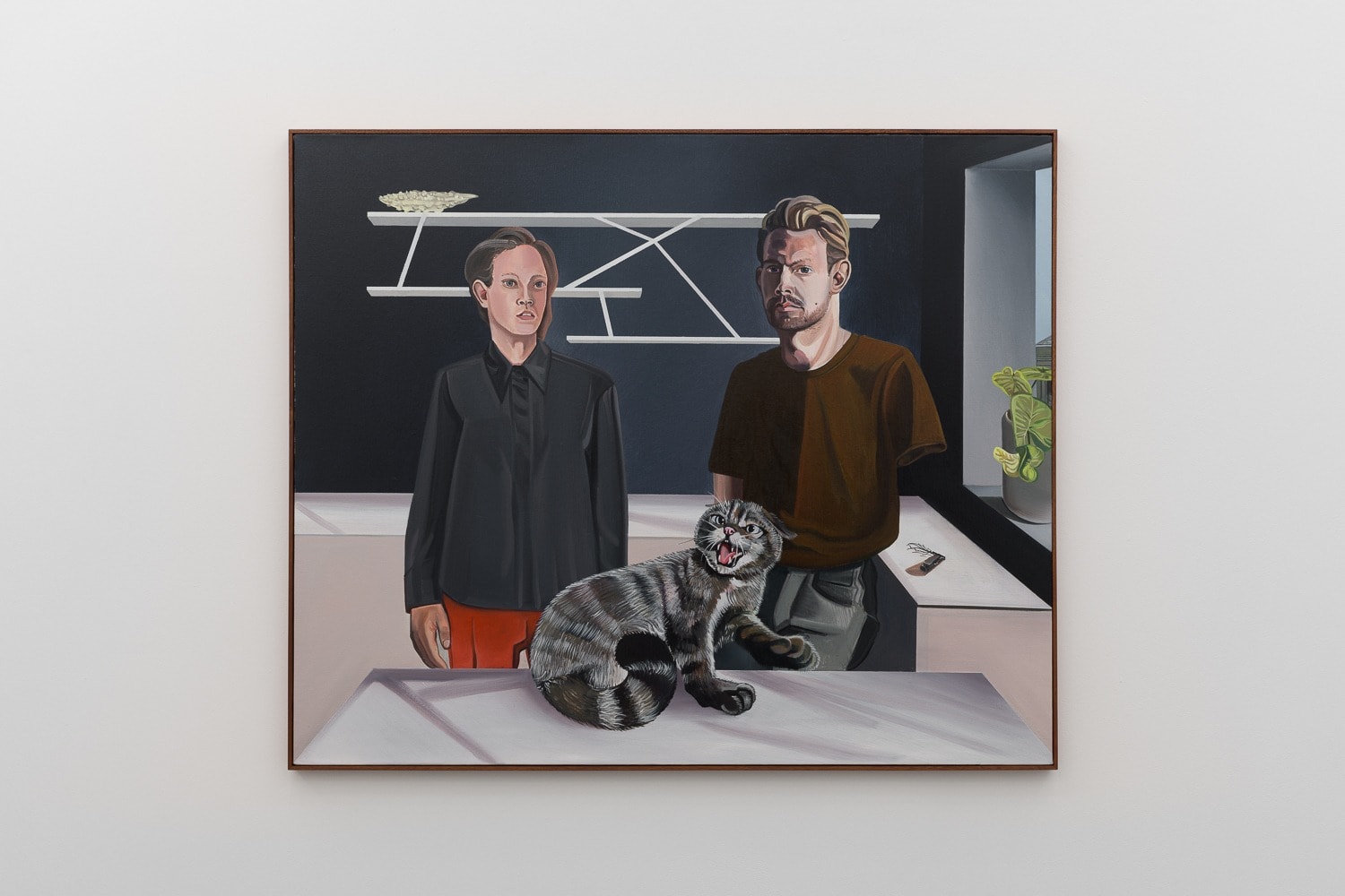 Two men and a grey cat on a kitchen counter in a painting by Alan Stanners