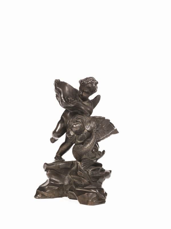 BRONZE GROUP DEPICTING WINGED PUTTO PLAYING WITH DOLPHIN ON ROCKY BASE, Central Italy, 18th century