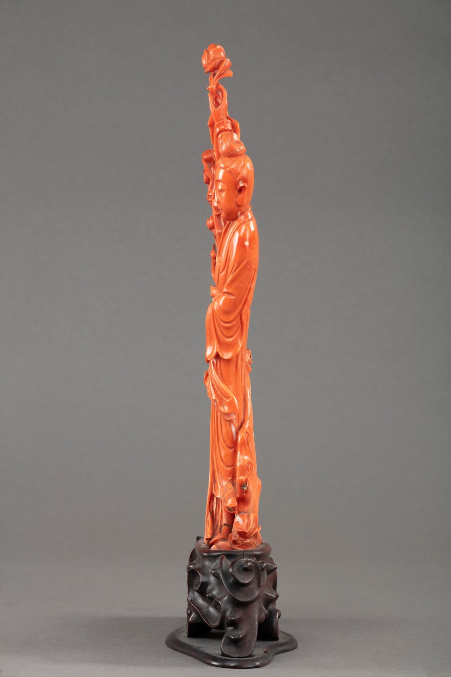 China, Coral Guanyin figure, resting on wooden base, XIX century