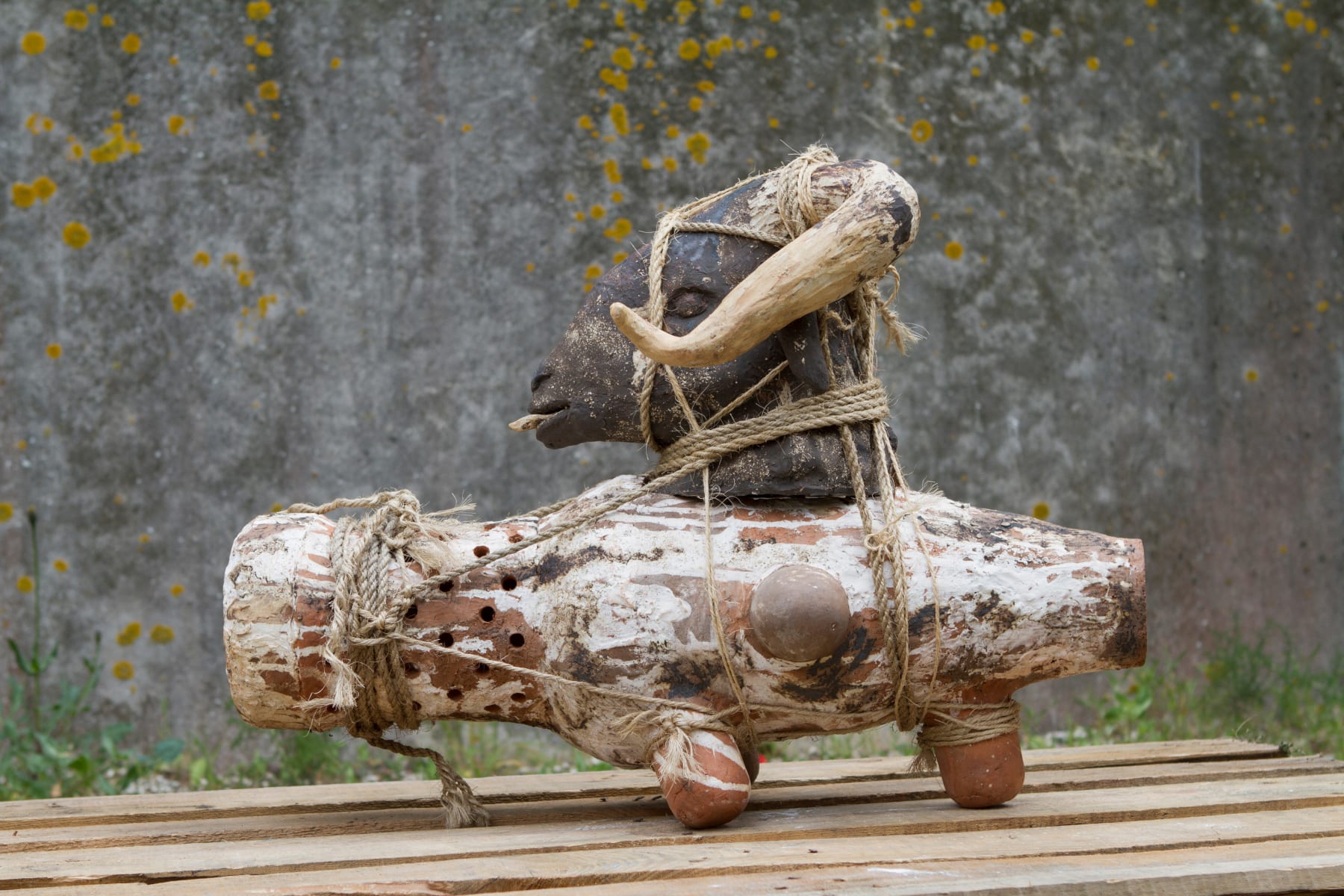 Sculpture in ceramic and ropes of a goat on an amphora by Chada