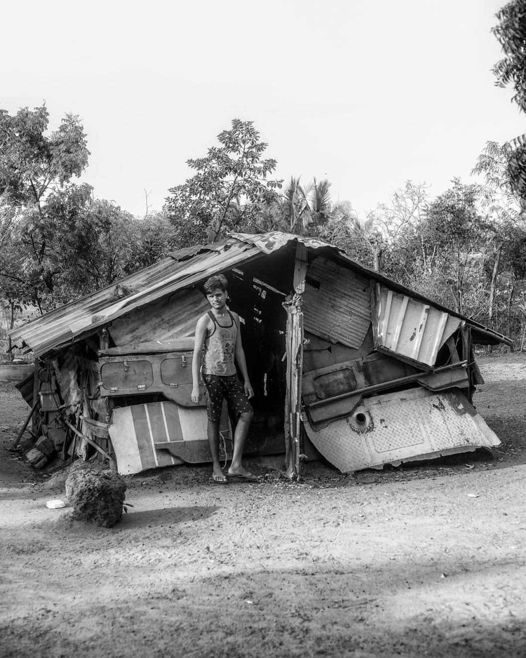 Tavish Gunasena, Boy outside duck coop, 2021