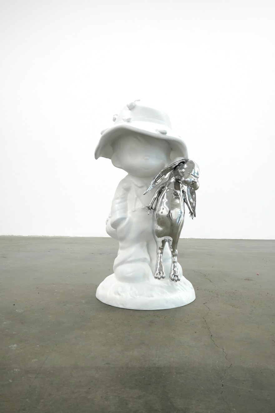 sculpture of a child wearing a hat and holding a bunny