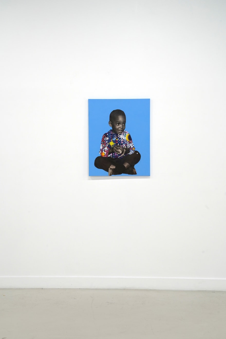 paper collage of a young child on a blue background