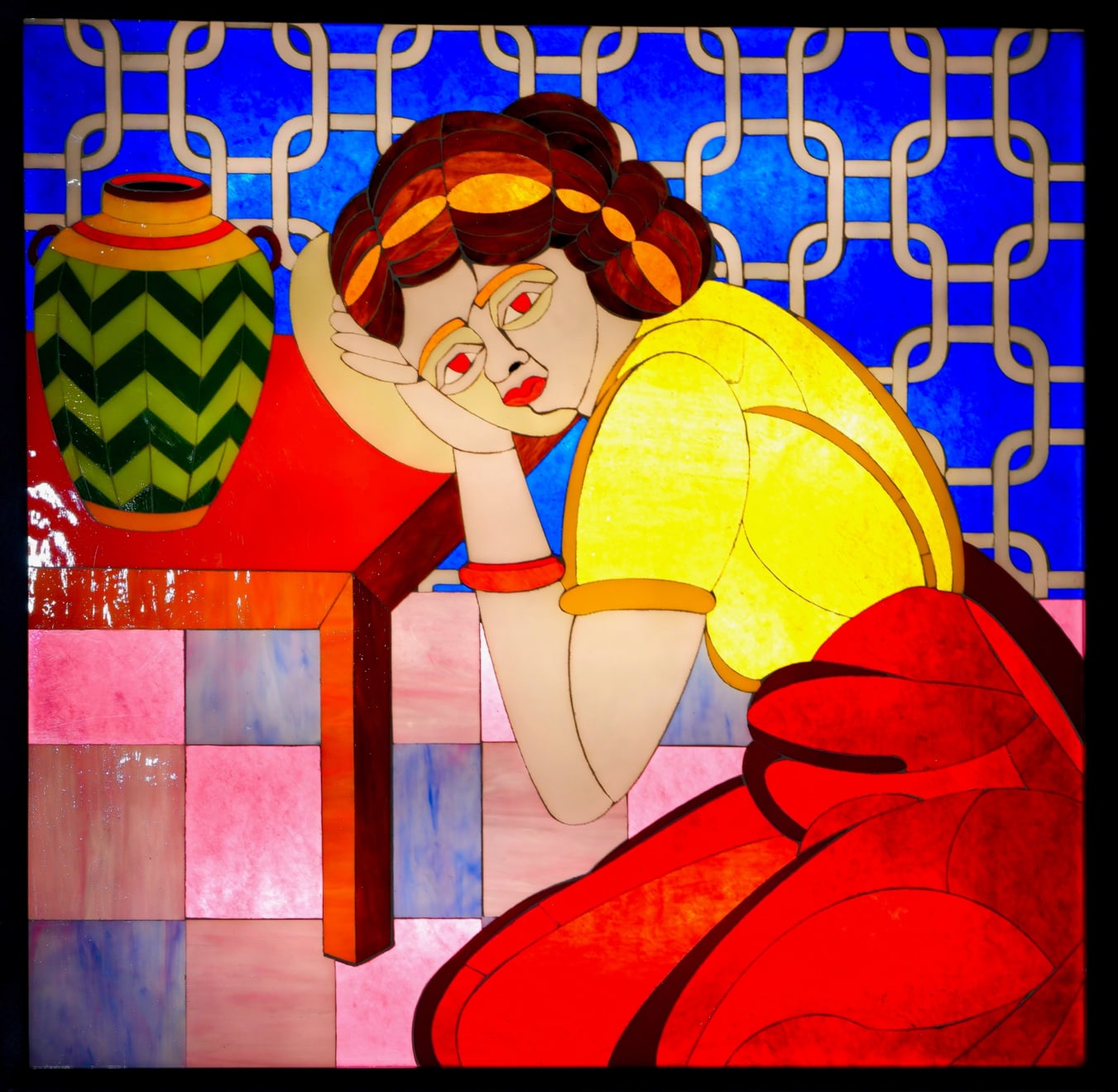 stained glass mosaic of a girl leaning on a table