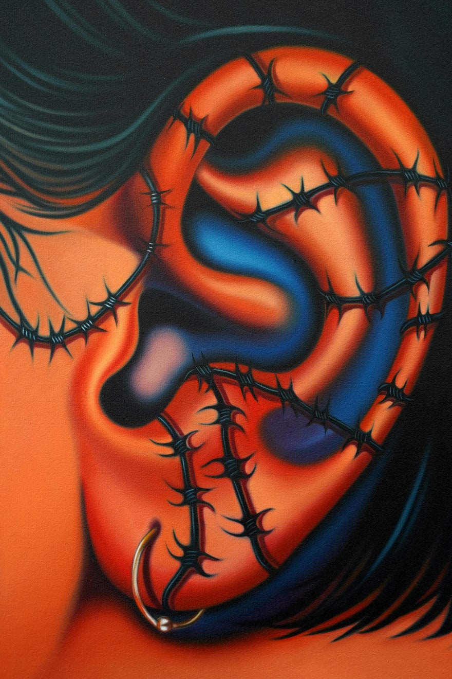 painting of an ear with barbed wire running along it