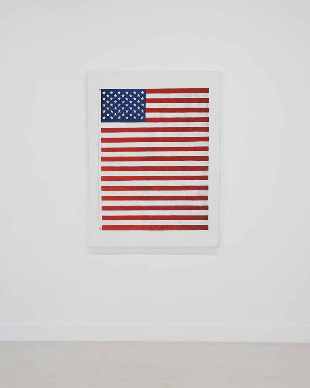 painting of an American Flag with extra red stripes making it longer