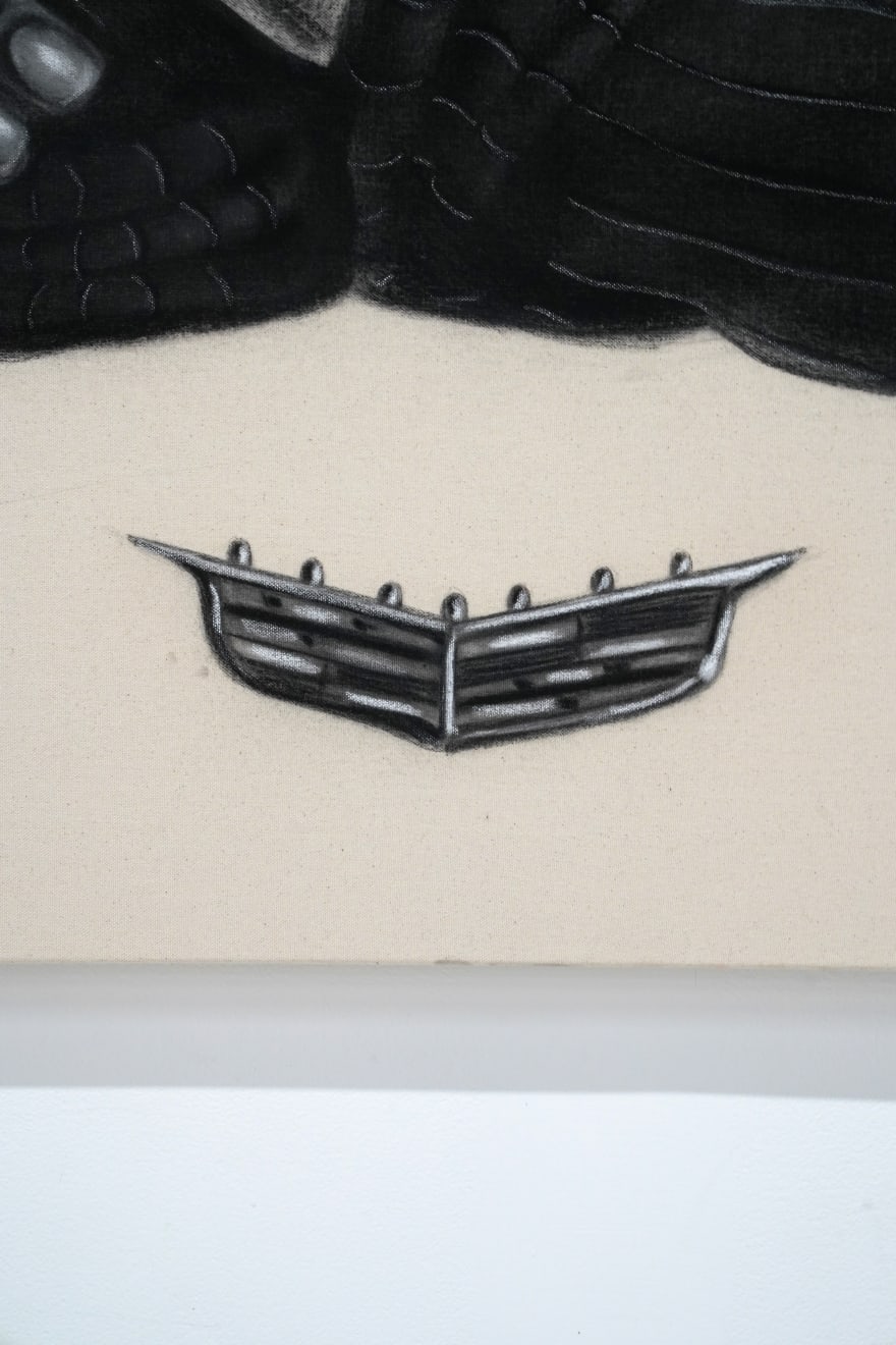 black and white charcoal drawing of a man lounging with a cadillac symbol below him