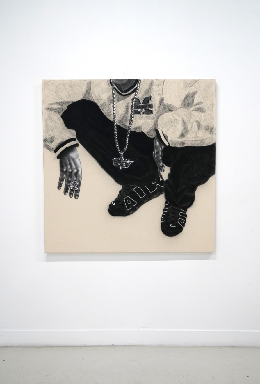 charcoal drawing of a man crouching wearing air jordans and a cadillac symbol necklace