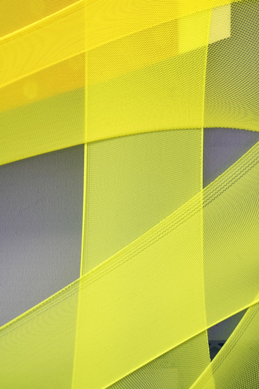 abstract fabric collage with a snippet of a photo of a person wearing a rain jacket