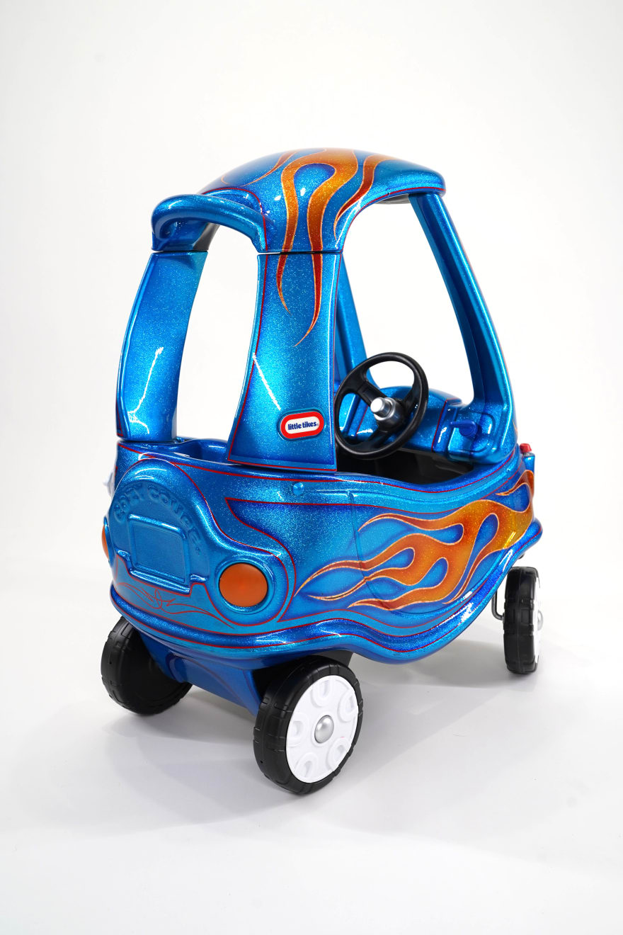photo of a blue childrens car with painted flames