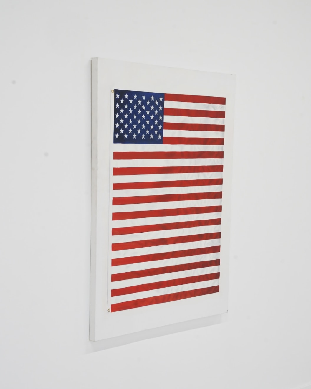 painting of an American Flag with extra red stripes making it longer