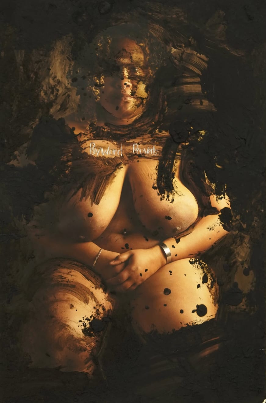 photograph of a naked women with black paint on the photos