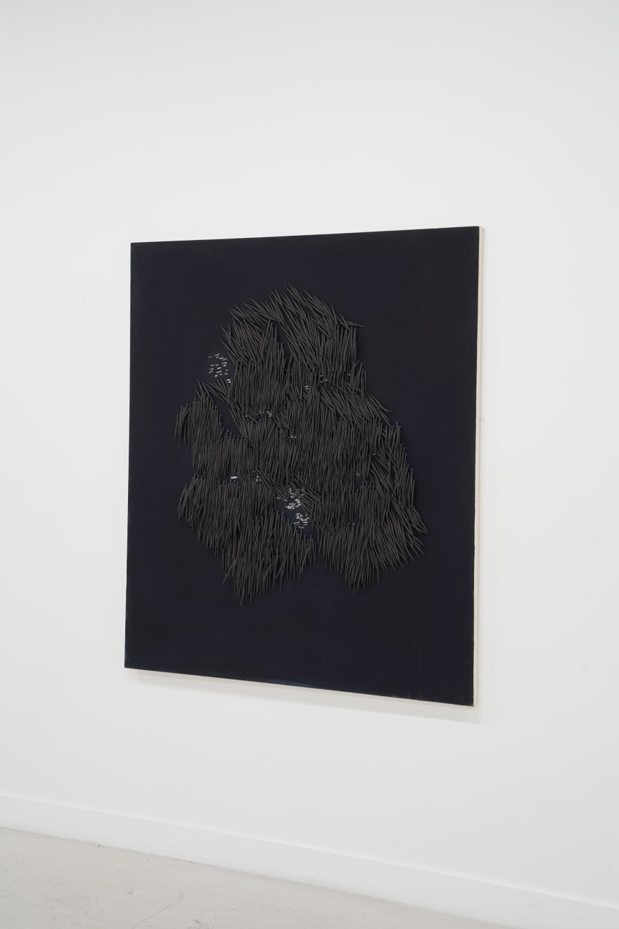 small ceramic needles sewn to a dark indigo canvas