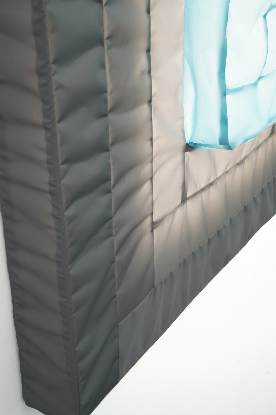 gray/blue fabric light hung on wall