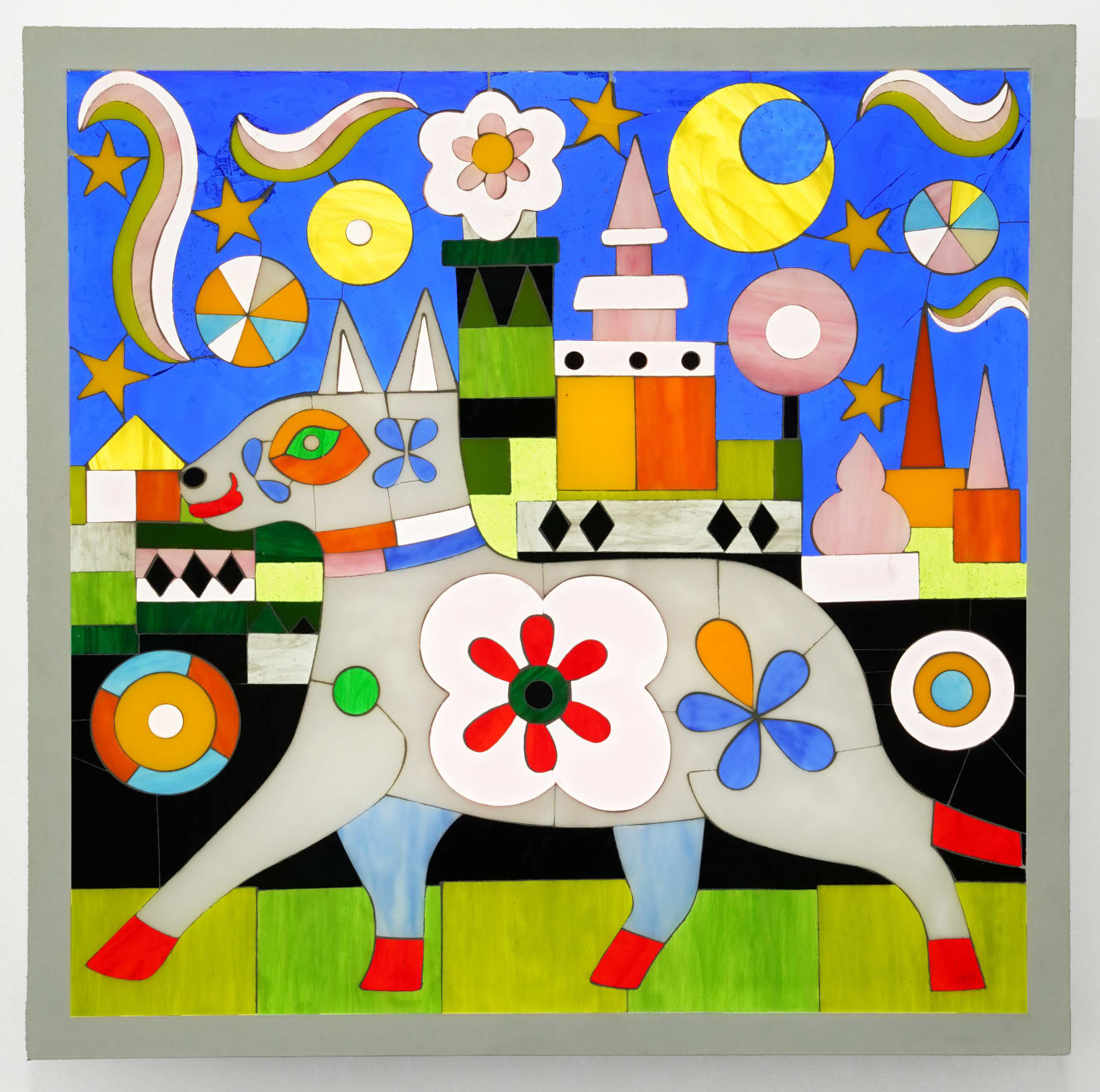 stained glass artwork with a dog and a castle