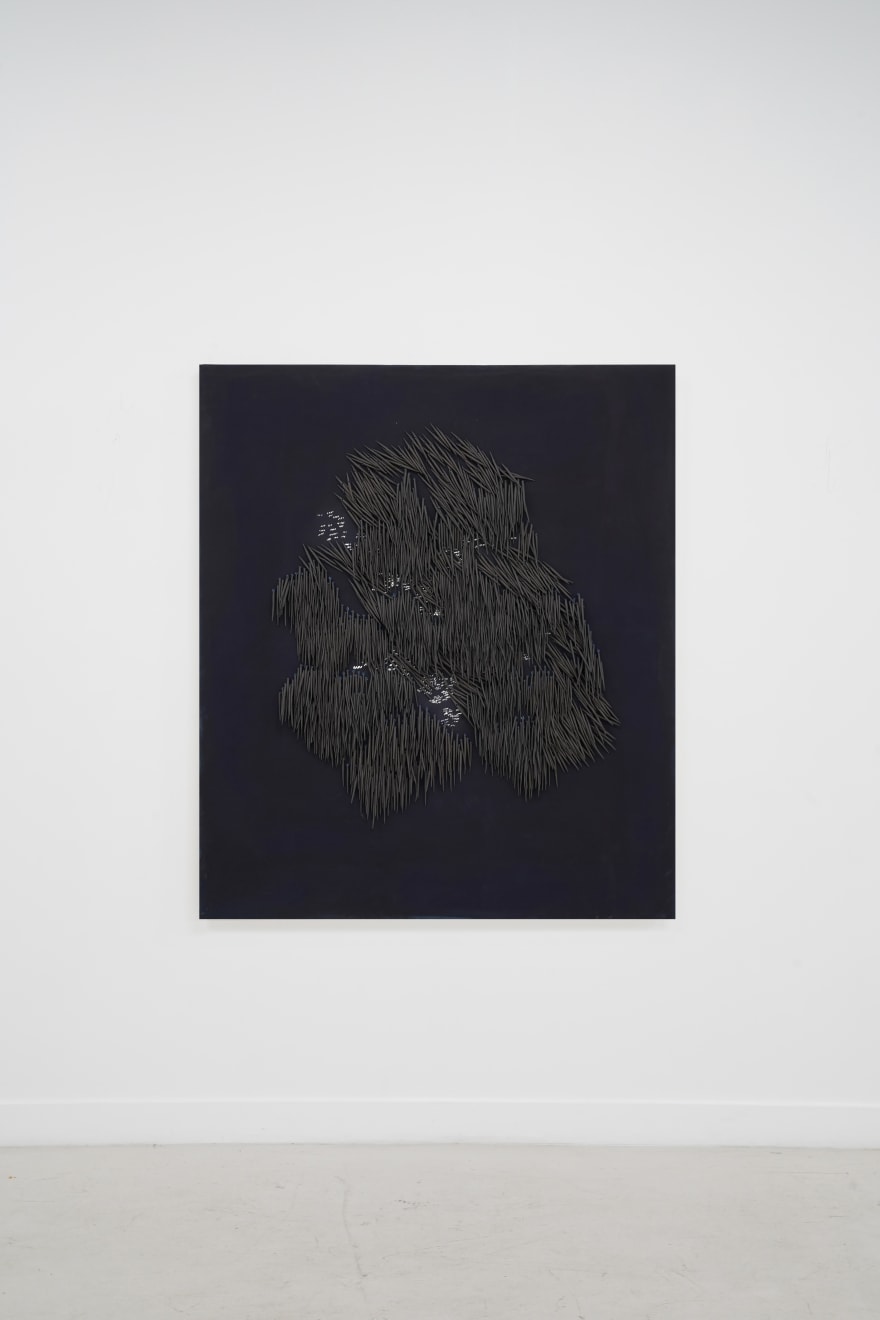 small ceramic needles sewn to a dark indigo canvas