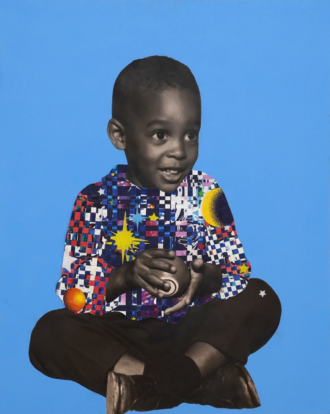 paper collage of a young child on a blue background
