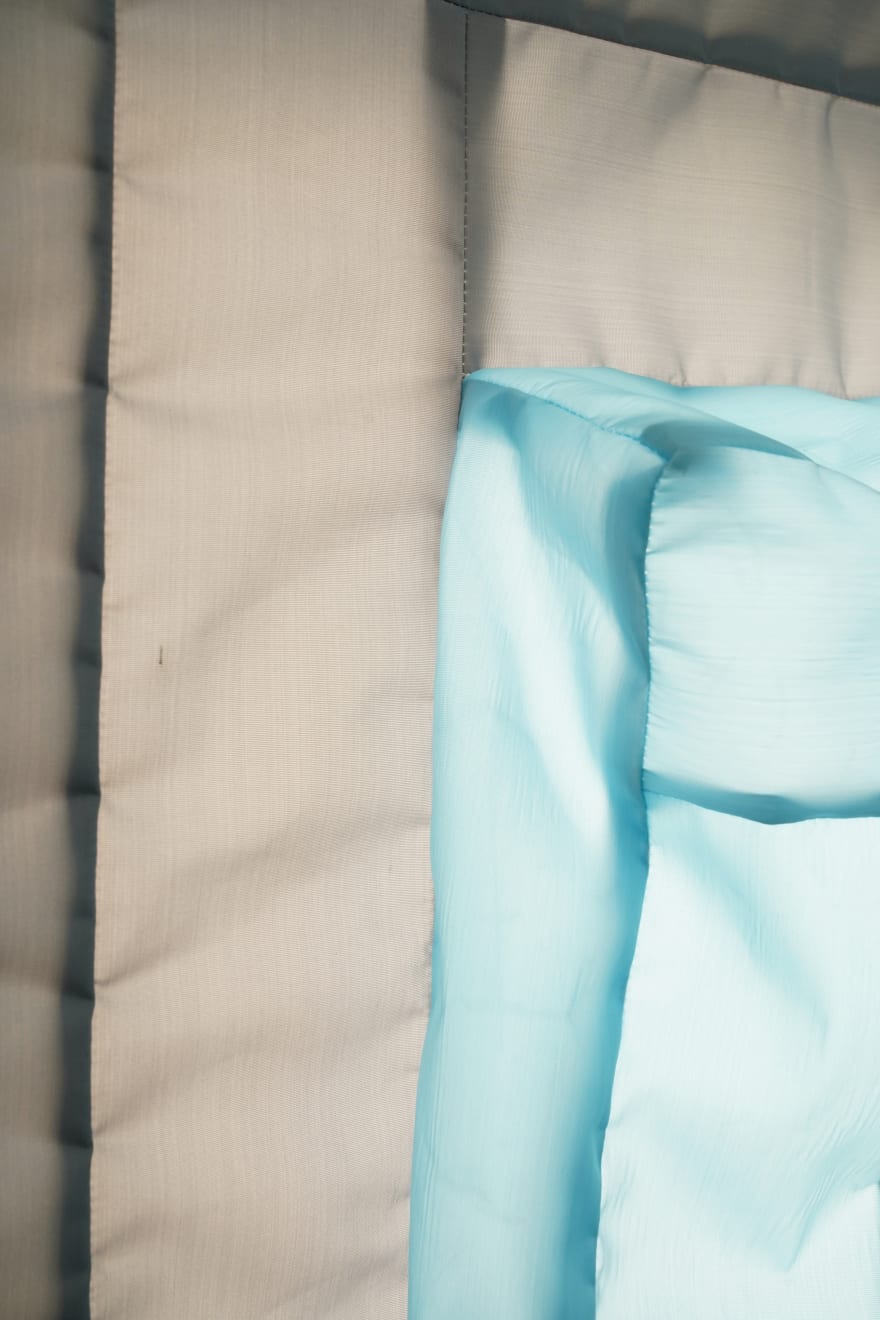 gray/blue fabric light hung on wall