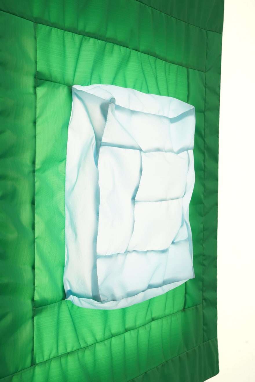 green fabric light hung on wall