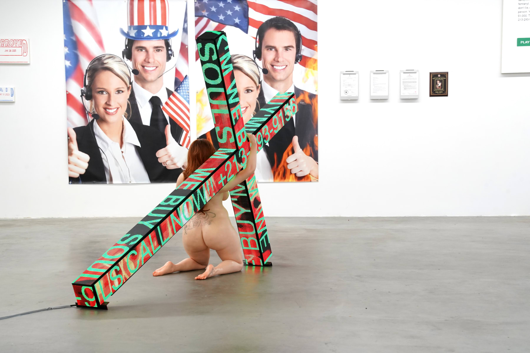 sculpture of a woman holding a cross