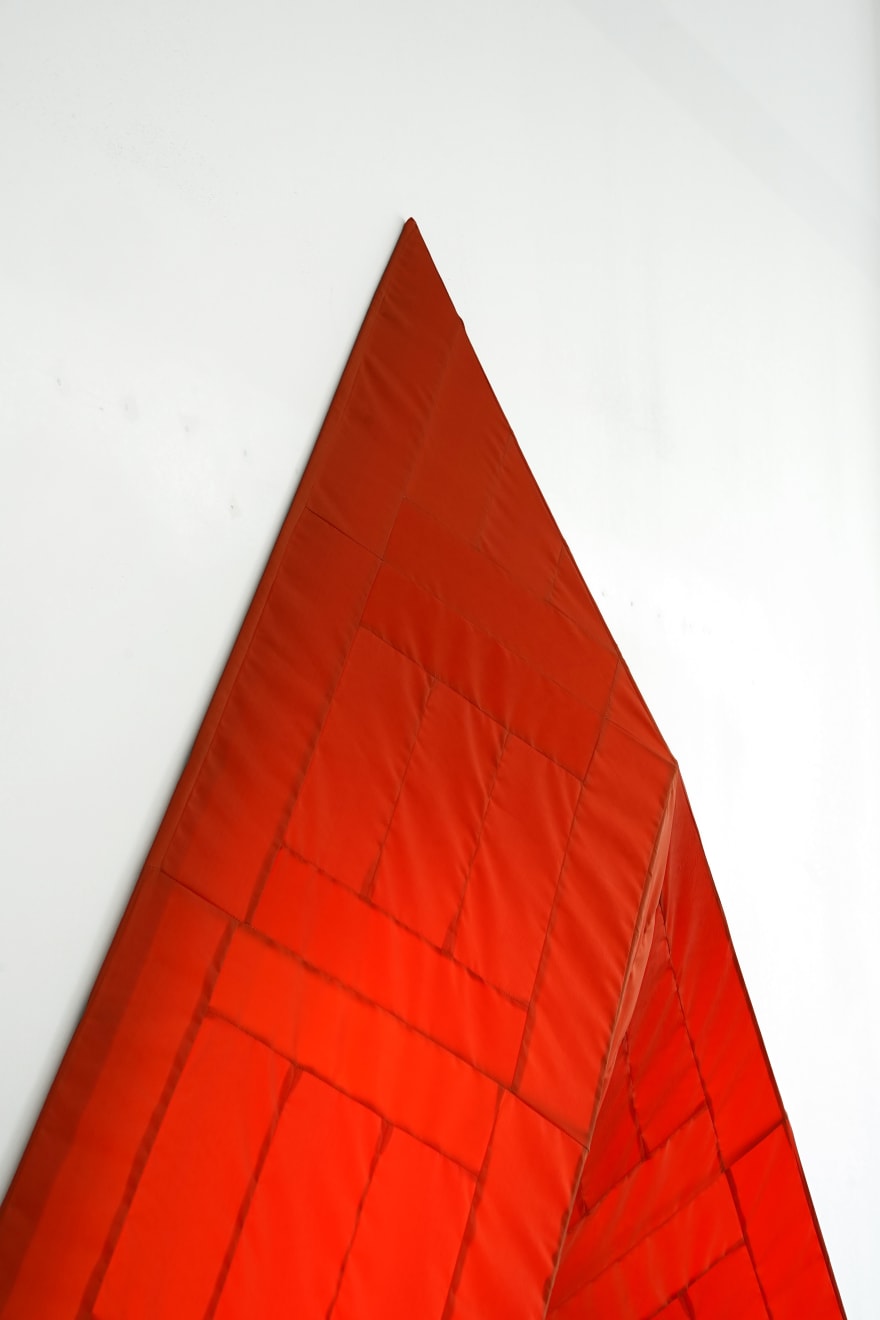 red arrow wall lamp mounted on a white wall