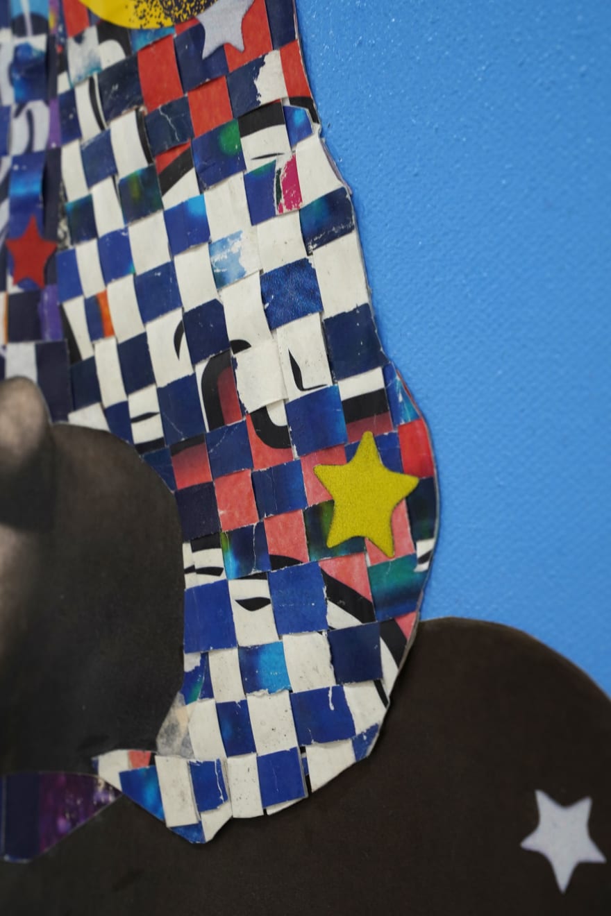 paper collage of a young child on a blue background