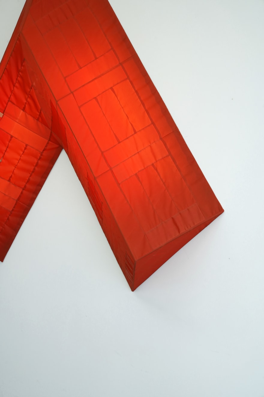 red arrow wall lamp mounted on a white wall