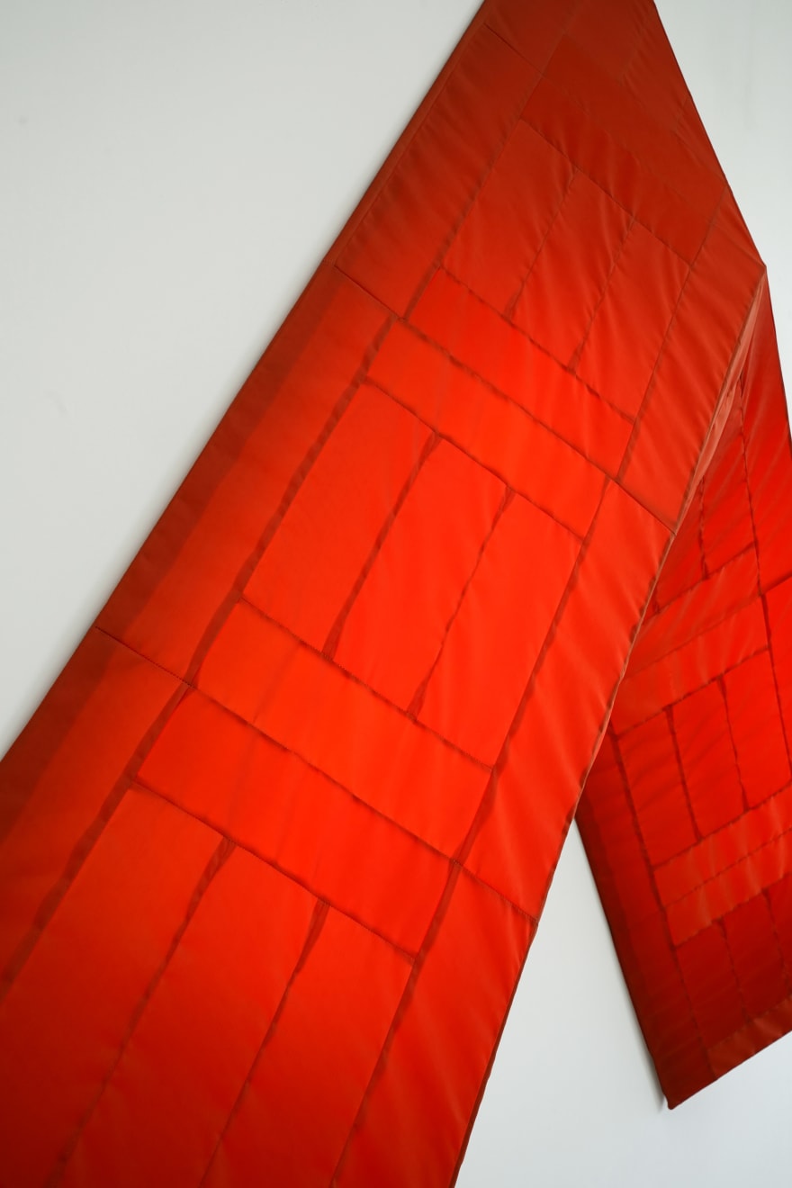 red arrow wall lamp mounted on a white wall