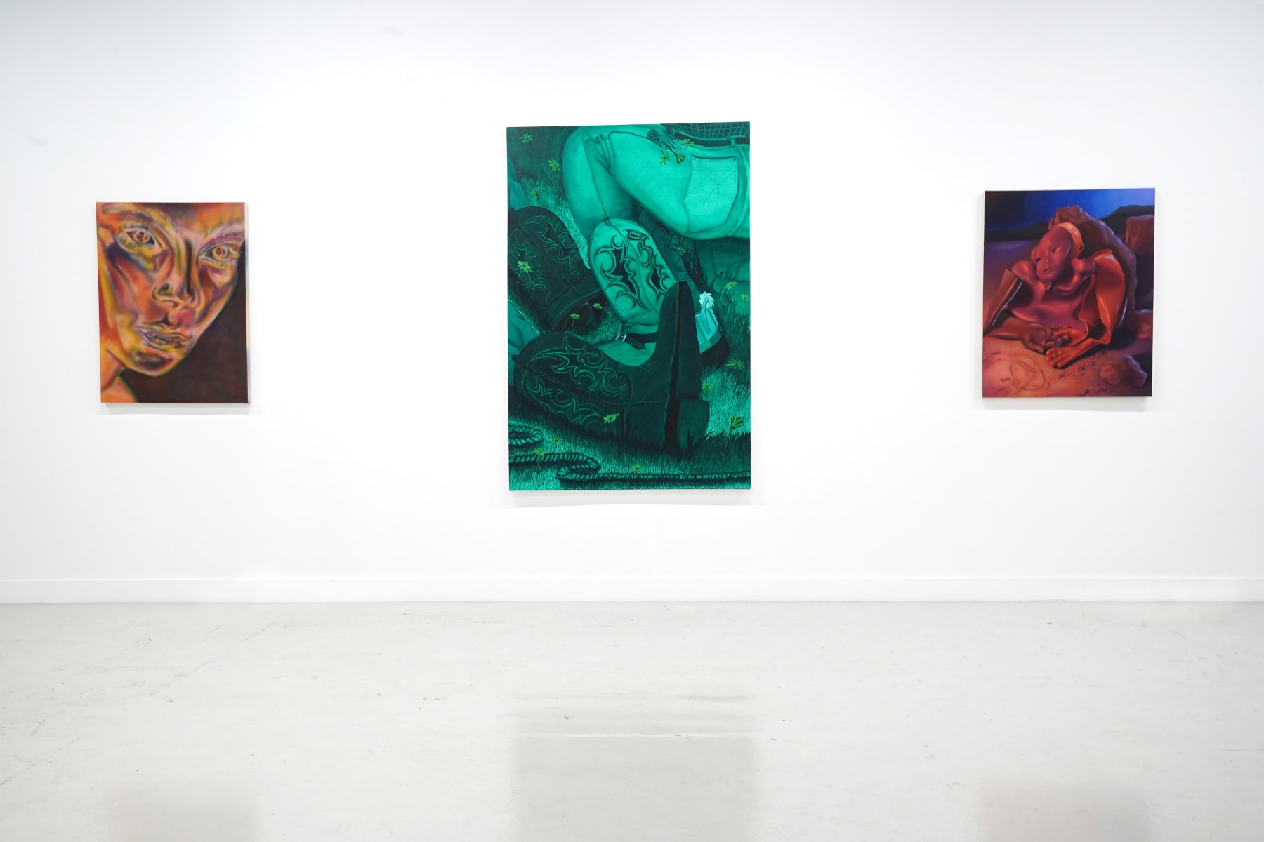 gallery view of three paintings hanging on a wall