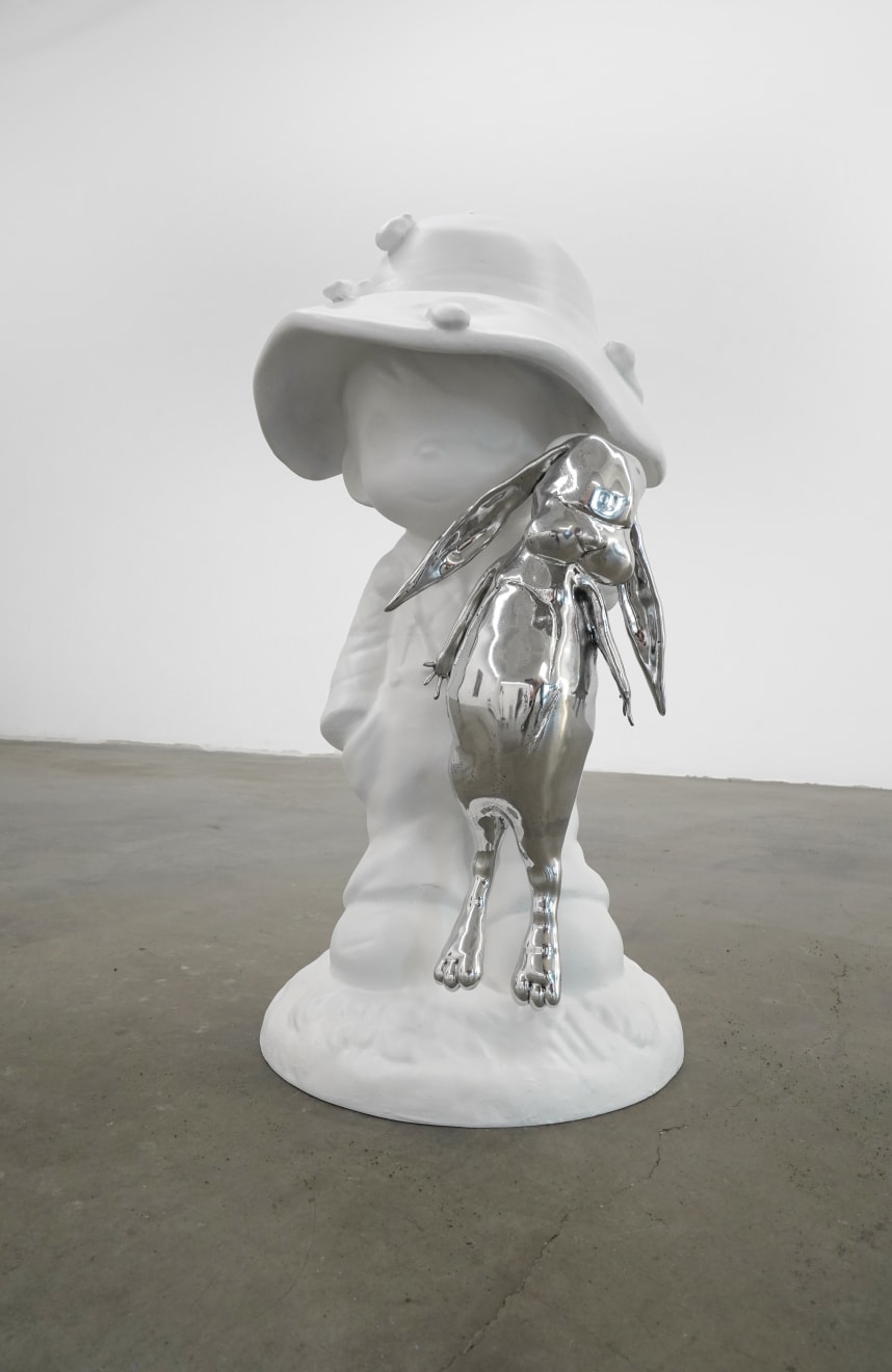 sculpture of a child wearing a hat and holding a bunny