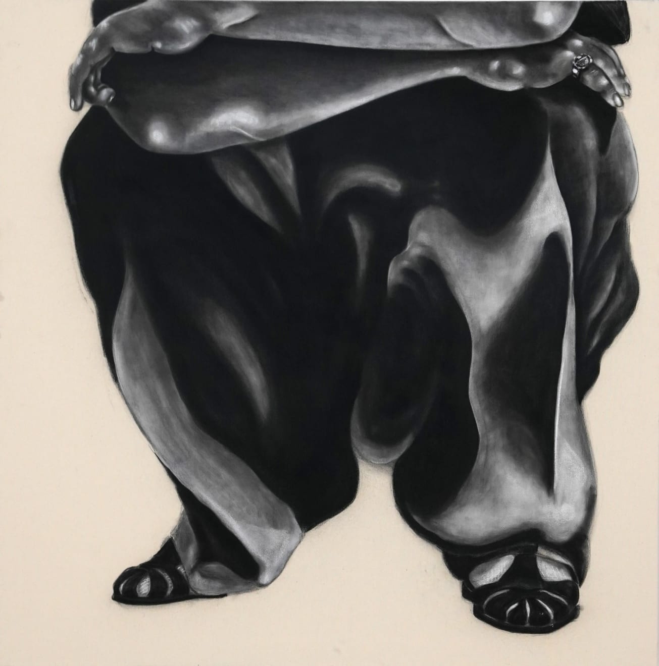 black and white charcoal drawing of a man crouching with baggy jeans